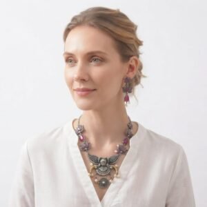 Beautiful oxidised silver necklace set featuring pink teardrop stones, lotus-inspired motifs, an intricate peacock pendant, and matching earrings.